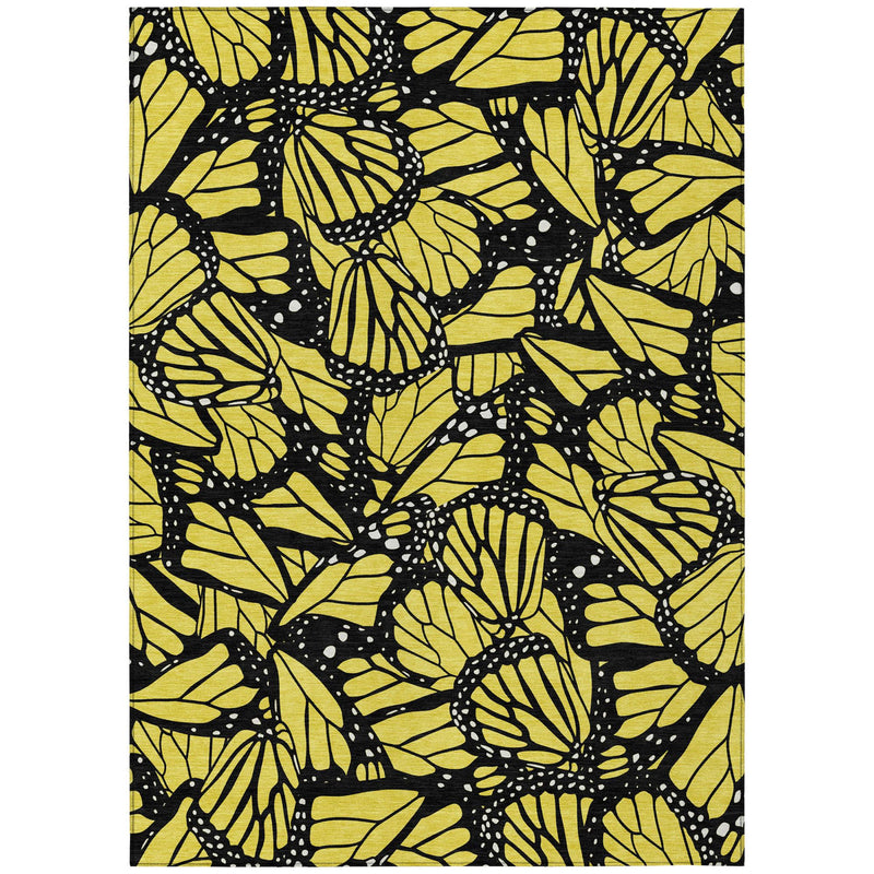Yellow and gold animal print area rug with black floral patterns, rectangular design