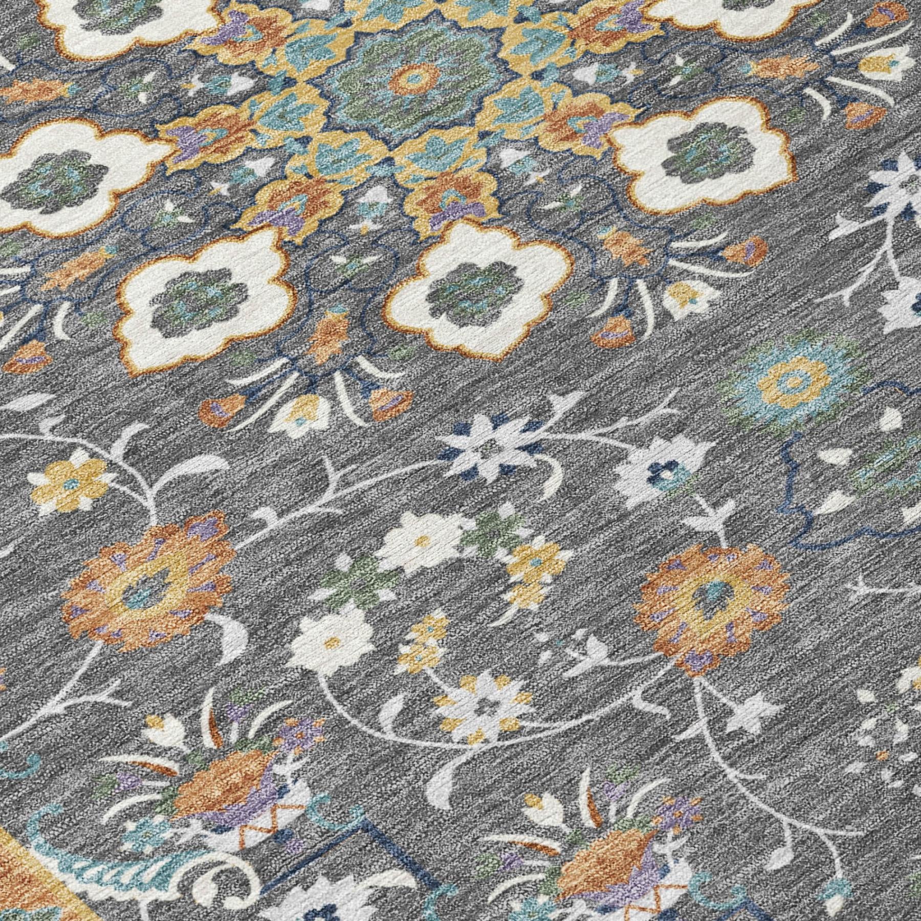 Gray area rug with intricate floral vine pattern in yellow, blue, and orange.
