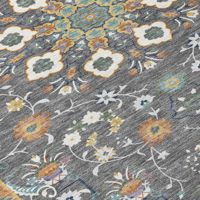 Gray area rug with intricate floral vine pattern in yellow, blue, and orange.