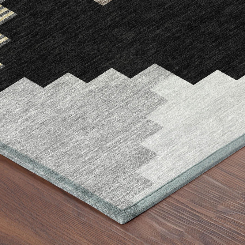 Geometric area rug with black and light gray diamond pattern, light blue border