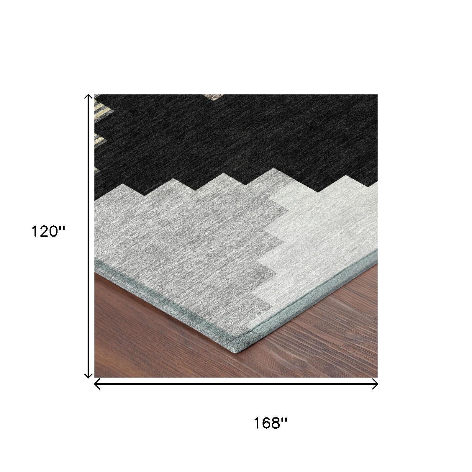 Corner view of geometric area rug with black top, light gray field, light blue edge