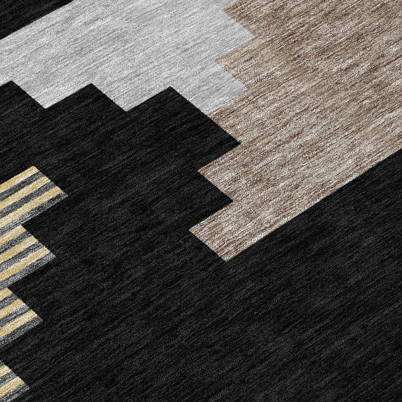 Close-up geometric rug in black, gray, and beige with small yellow stripe accents