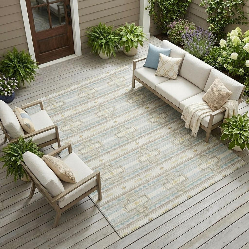 Ivory and light blue tribal pattern indoor outdoor area rug on a covered patio floor