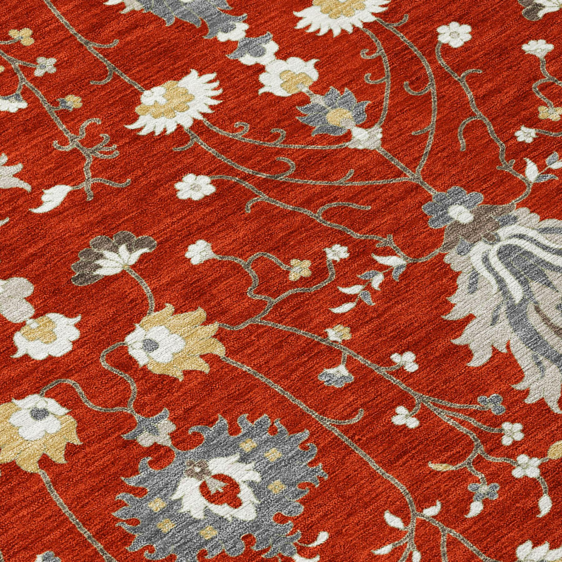 Red oriental area rug with beige and gray floral vine pattern, close-up texture