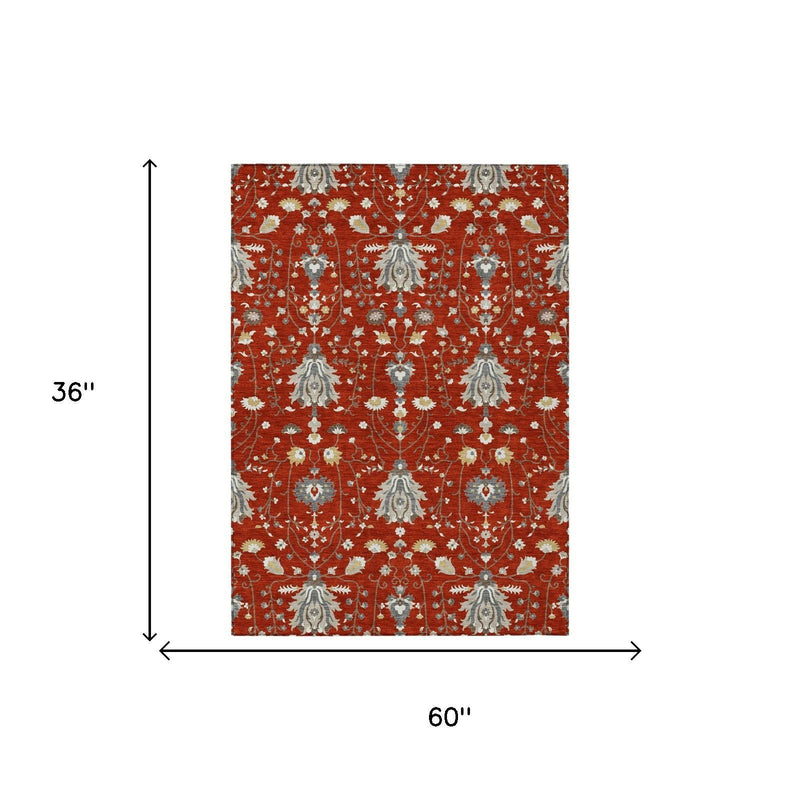 Red oriental area rug with floral medallion pattern, 60 in x 36 in