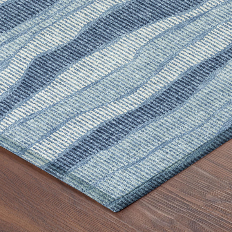 Denim blue and light blue striped area rug with tight woven wave pattern