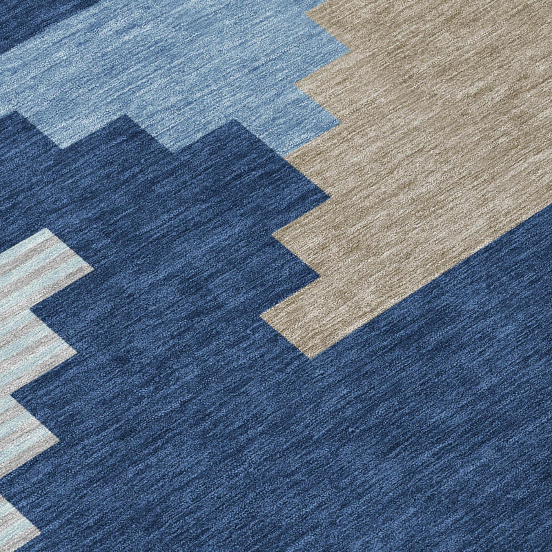 Close-up indoor/outdoor area rug with navy and light-blue geometric pattern and beige
