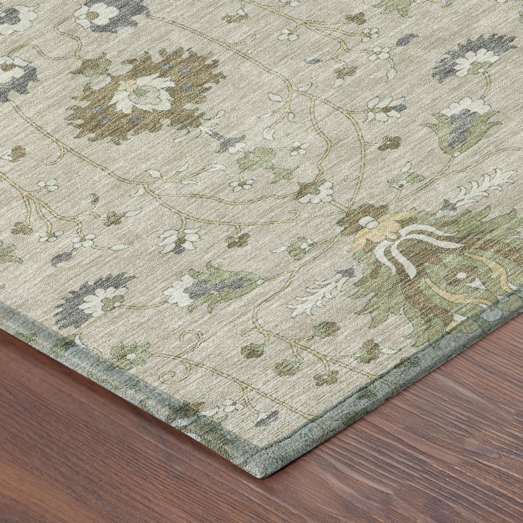 Beige area rug corner with ornate floral lines and medallion motifs in green and gray