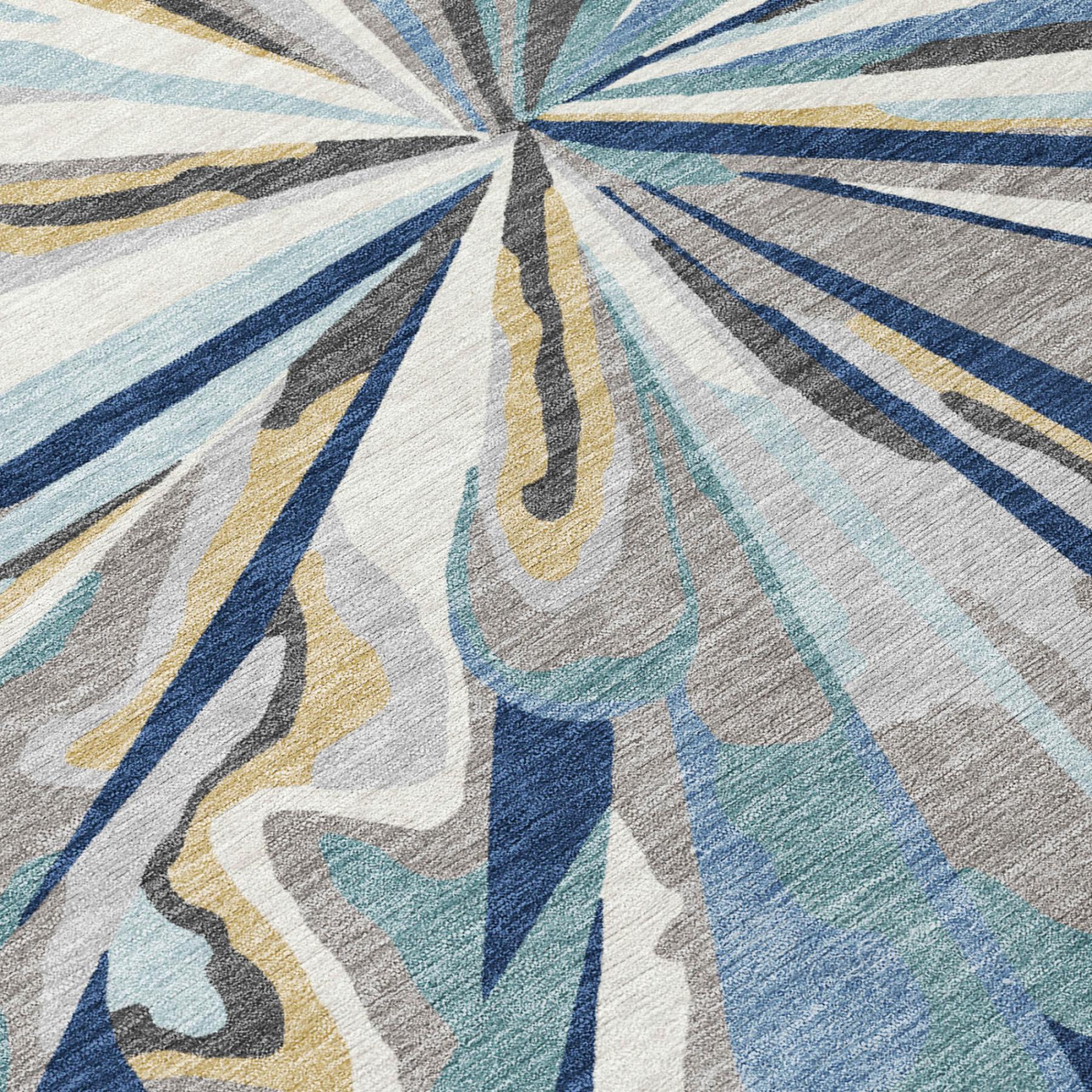 Rug close-up showing radial abstract lines in blue, teal, beige, and gray tones