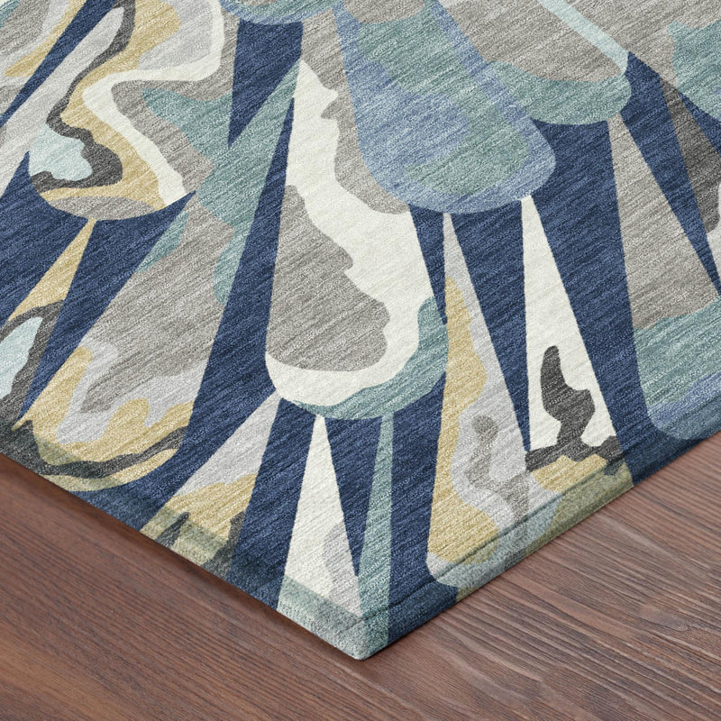 Navy blue abstract area rug corner detail with radial stripes and faded blue tones