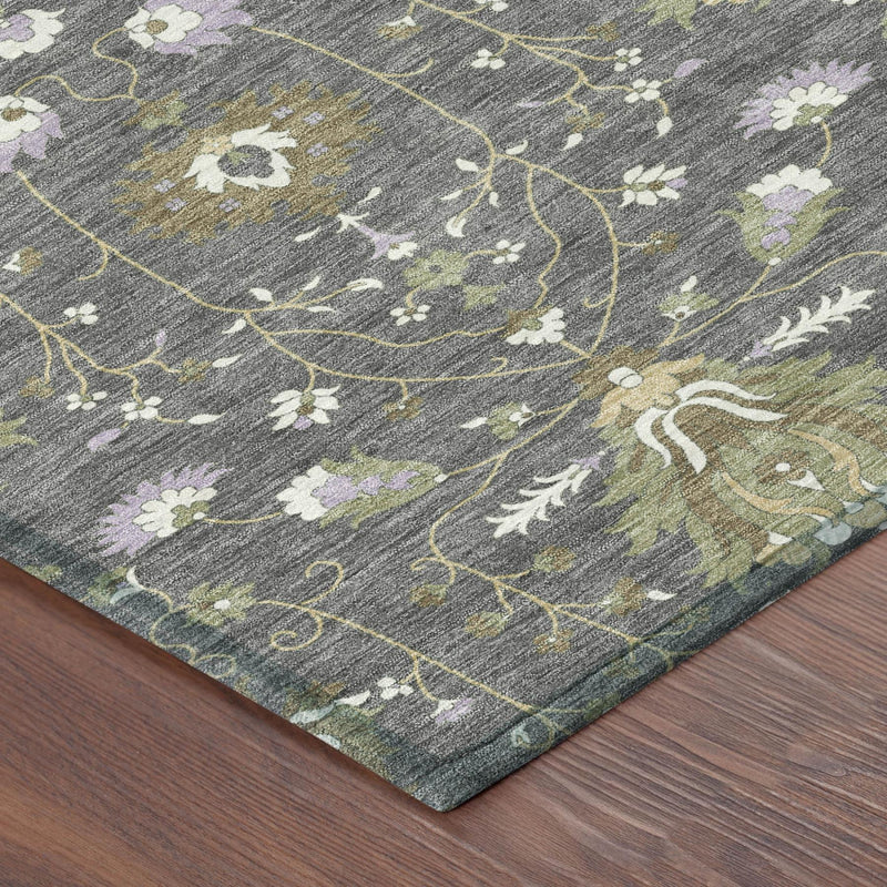 Gray oriental area rug corner detail with scrolling vine outlines and small flowers.