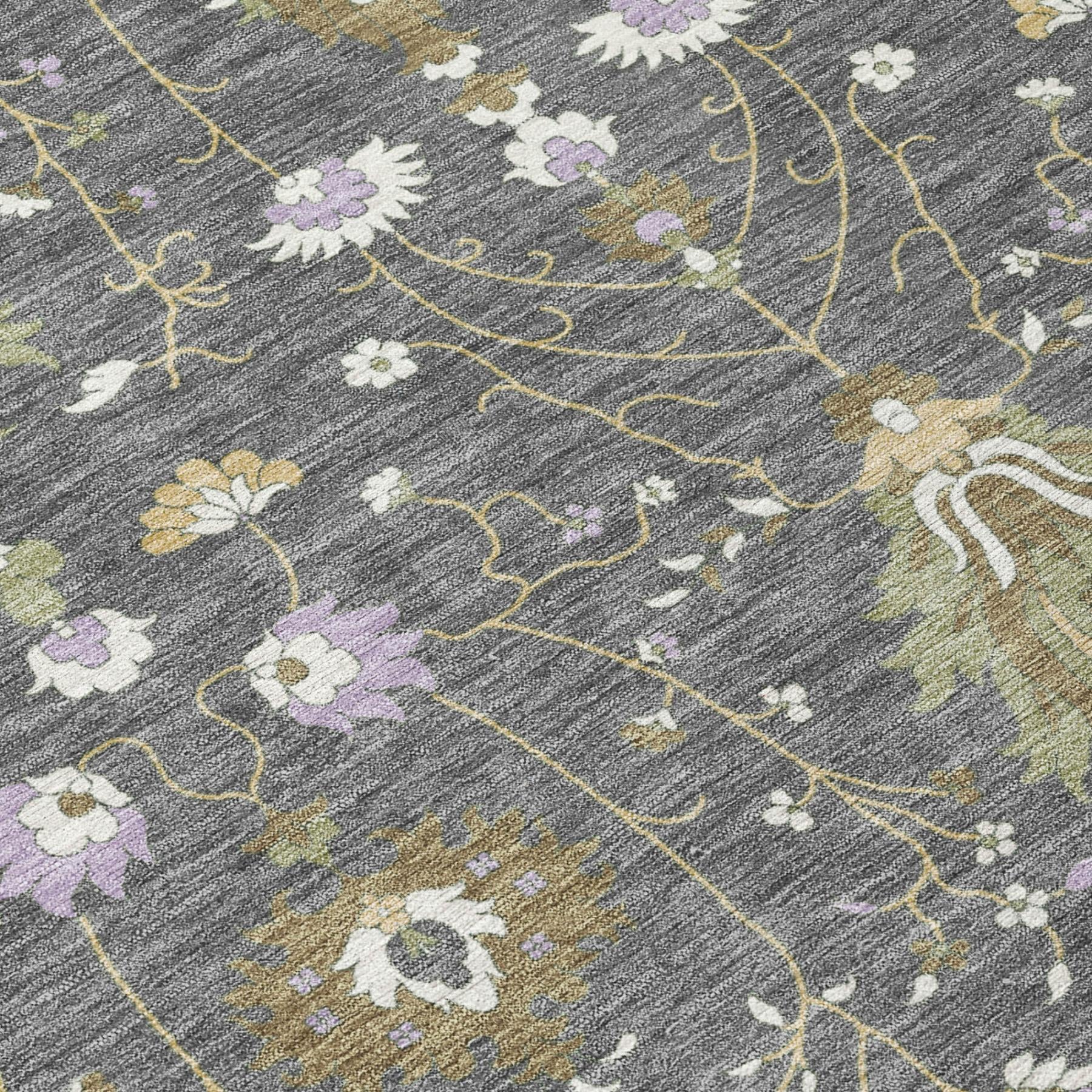 Gray oriental area rug close-up with yellow-green vine lines and white/lavender flowers.