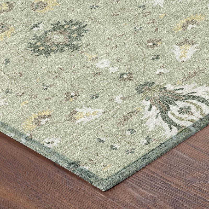 Green and beige oriental area rug corner with floral medallion pattern and bound edge