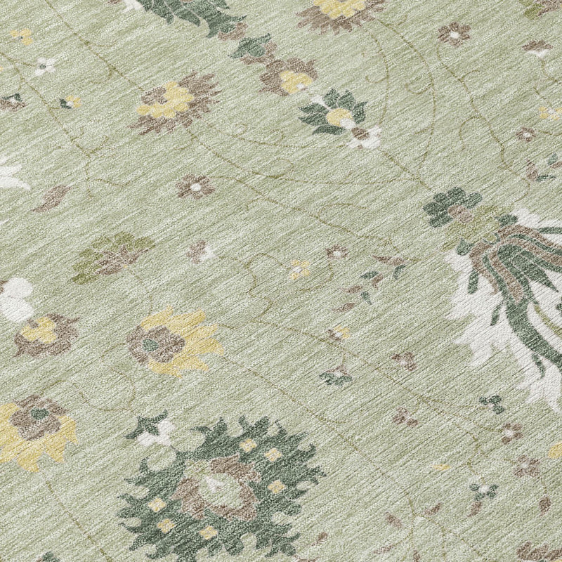 Close-up of green and beige oriental area rug fabric with floral motif details