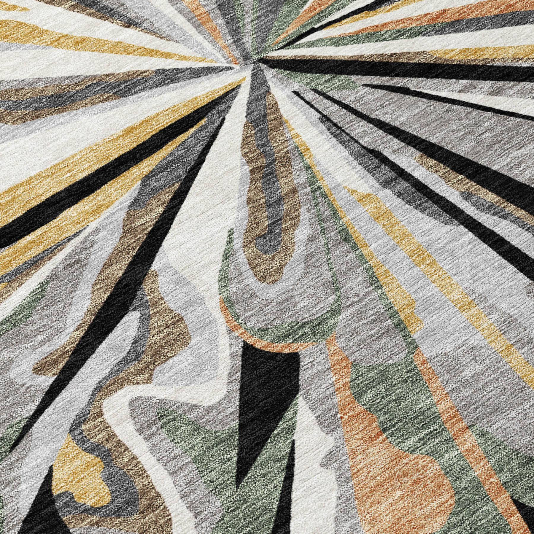 Close-up of abstract area rug rays in cream, charcoal, gold, green, and rust tones