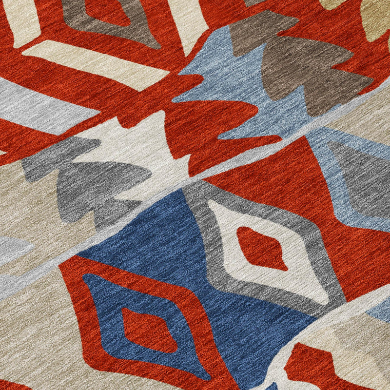 Geometric area rug close-up with red, blue, gray, and beige woven pattern