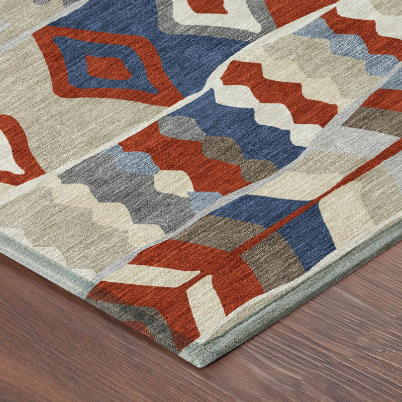 Round area rug corner with red, blue, gray, and beige geometric design and border