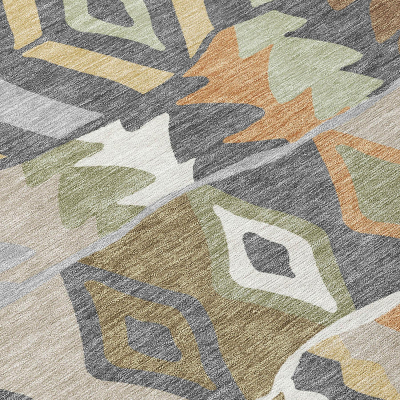 Round rug close-up with distressed geometric shapes in gray, green, and orange