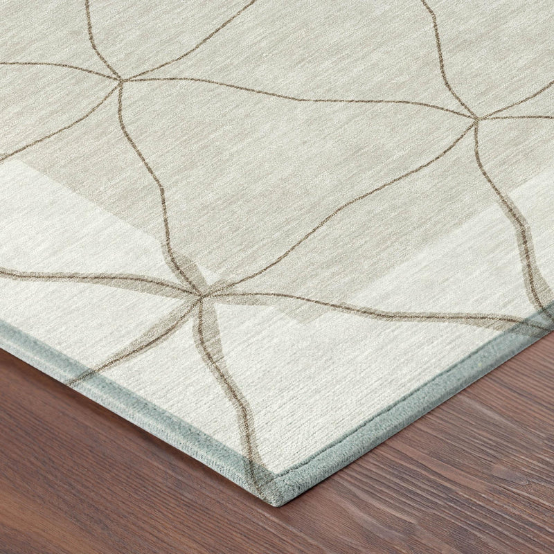 Corner of ivory rug with taupe diamond grid pattern and light blue backing edge
