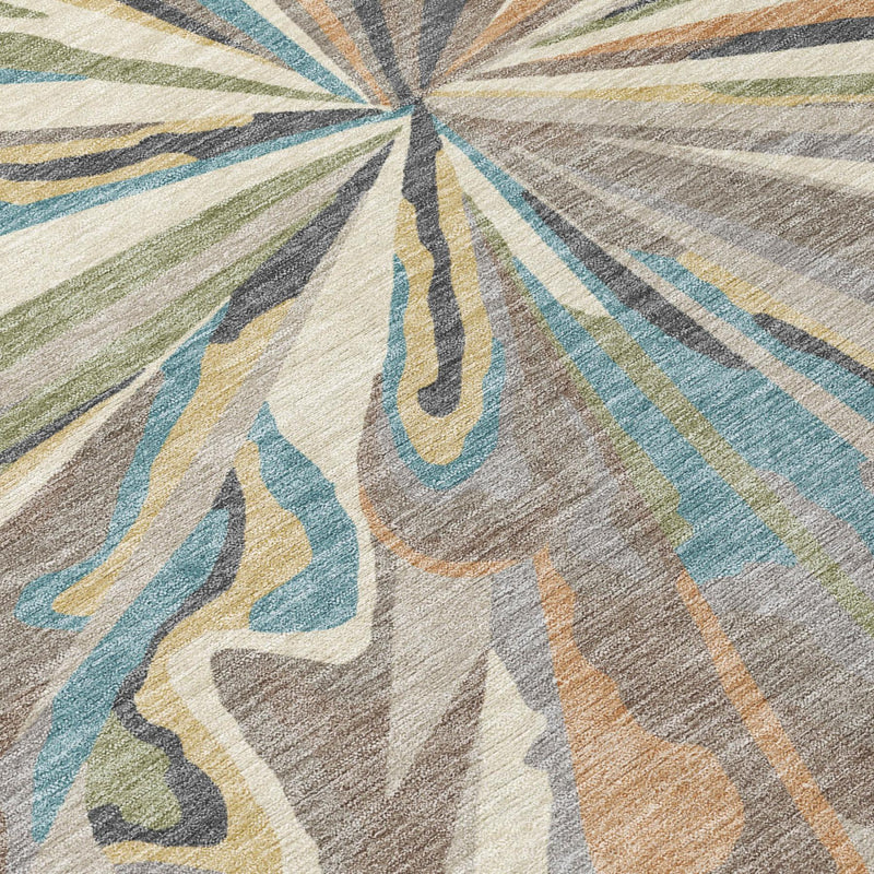 Close-up of sunburst abstract rug design with beige, teal, blue, and brown strokes.