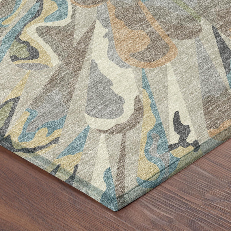 Rug corner detail showing abstract pattern and flat woven texture on wood floor.