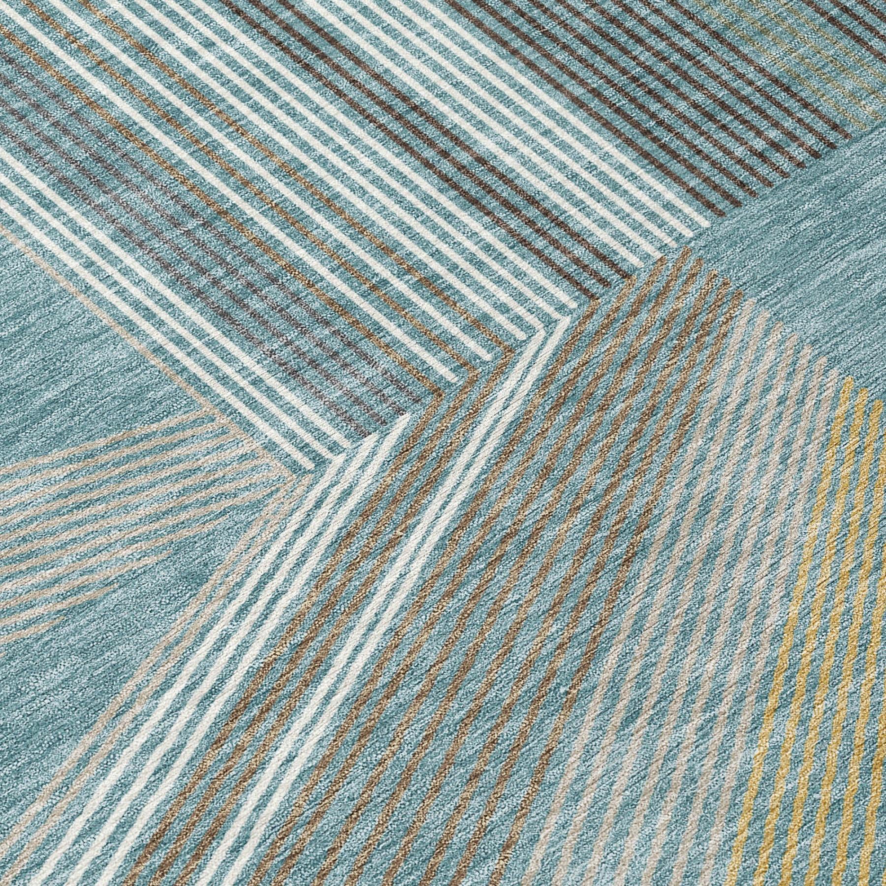 Teal blue geometric area rug close-up with white and gold stripe lines and borders