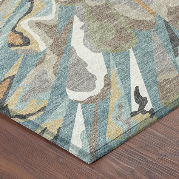 Teal blue and beige abstract area rug with layered fan motif and visible border edge