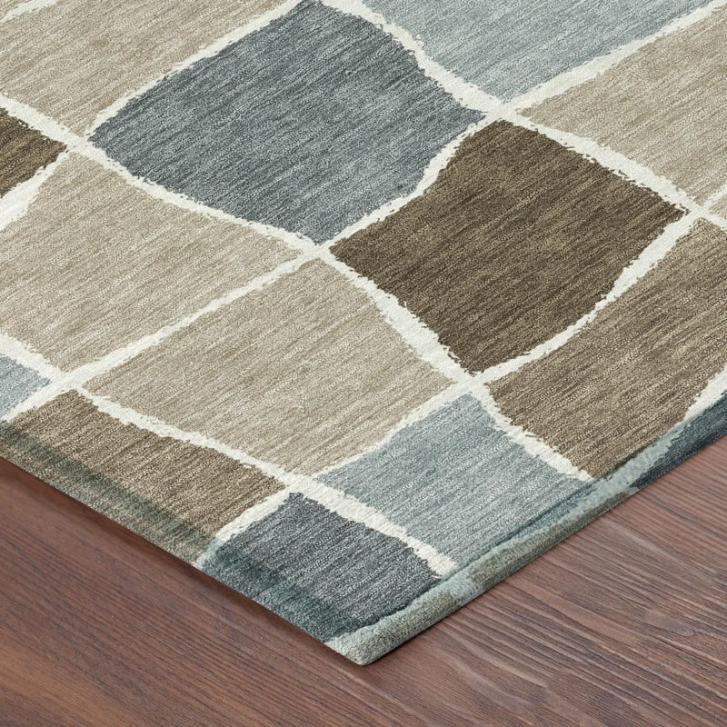 Geometric area rug corner with beige, brown, and light blue grid blocks and white border lines