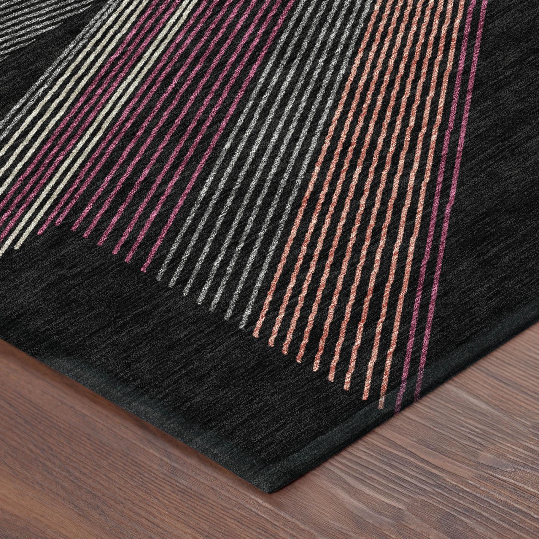 Geometric striped area rug corner in dark black with magenta, orange, and gray lines