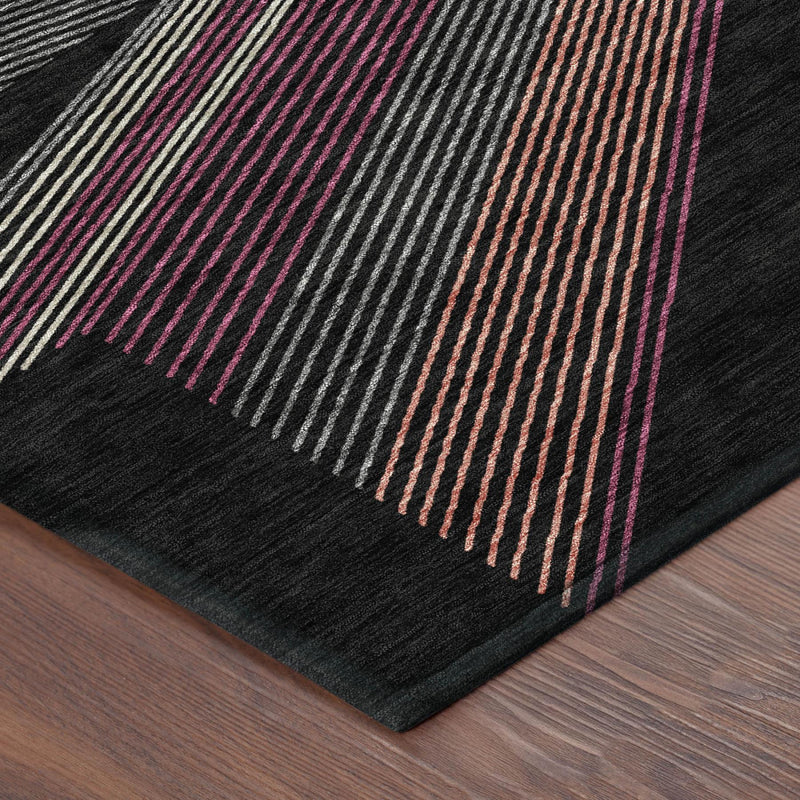 Geometric striped area rug corner in dark black with magenta, orange, and gray lines
