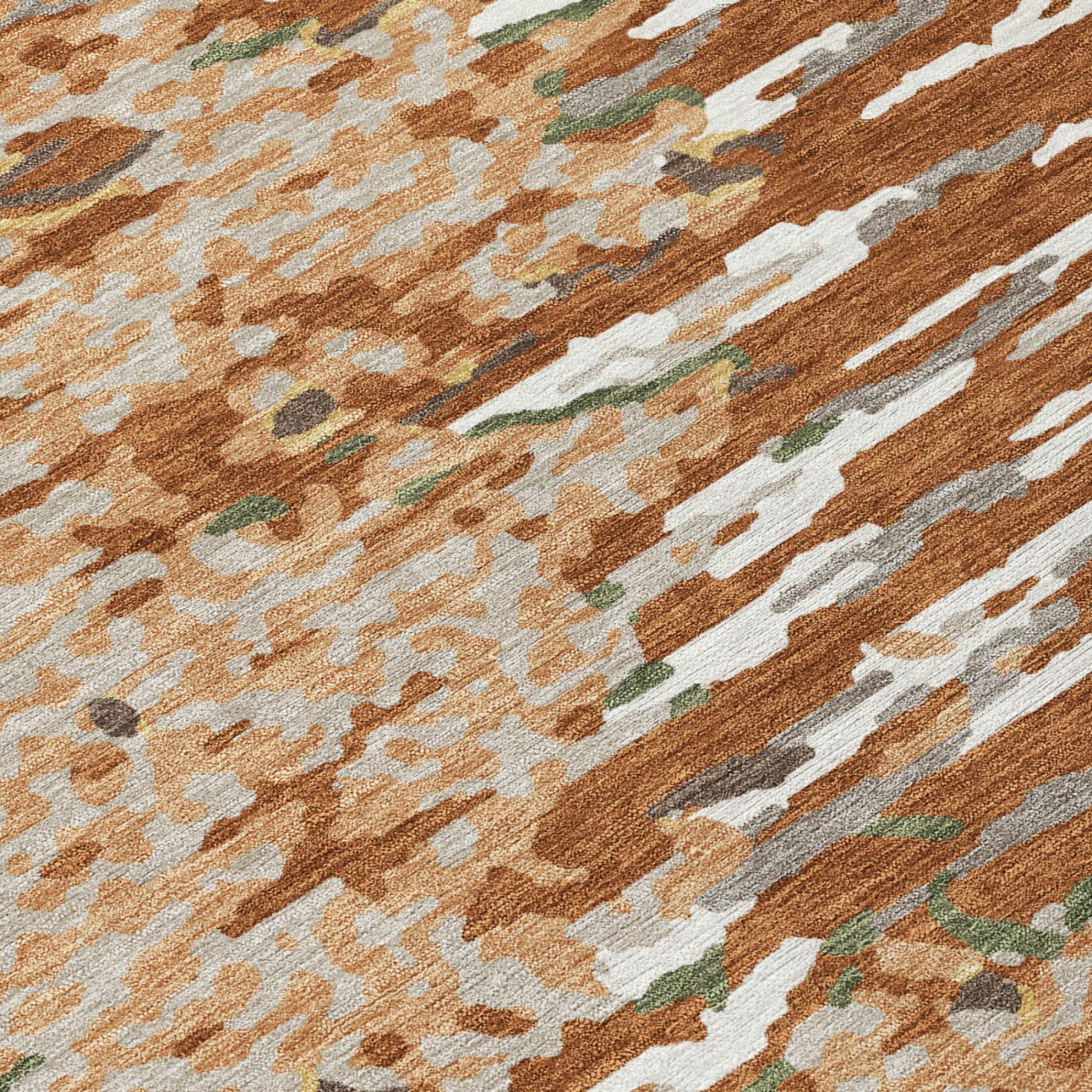Close-up of abstract area rug pile with orange, beige, white, green, and gray streaks