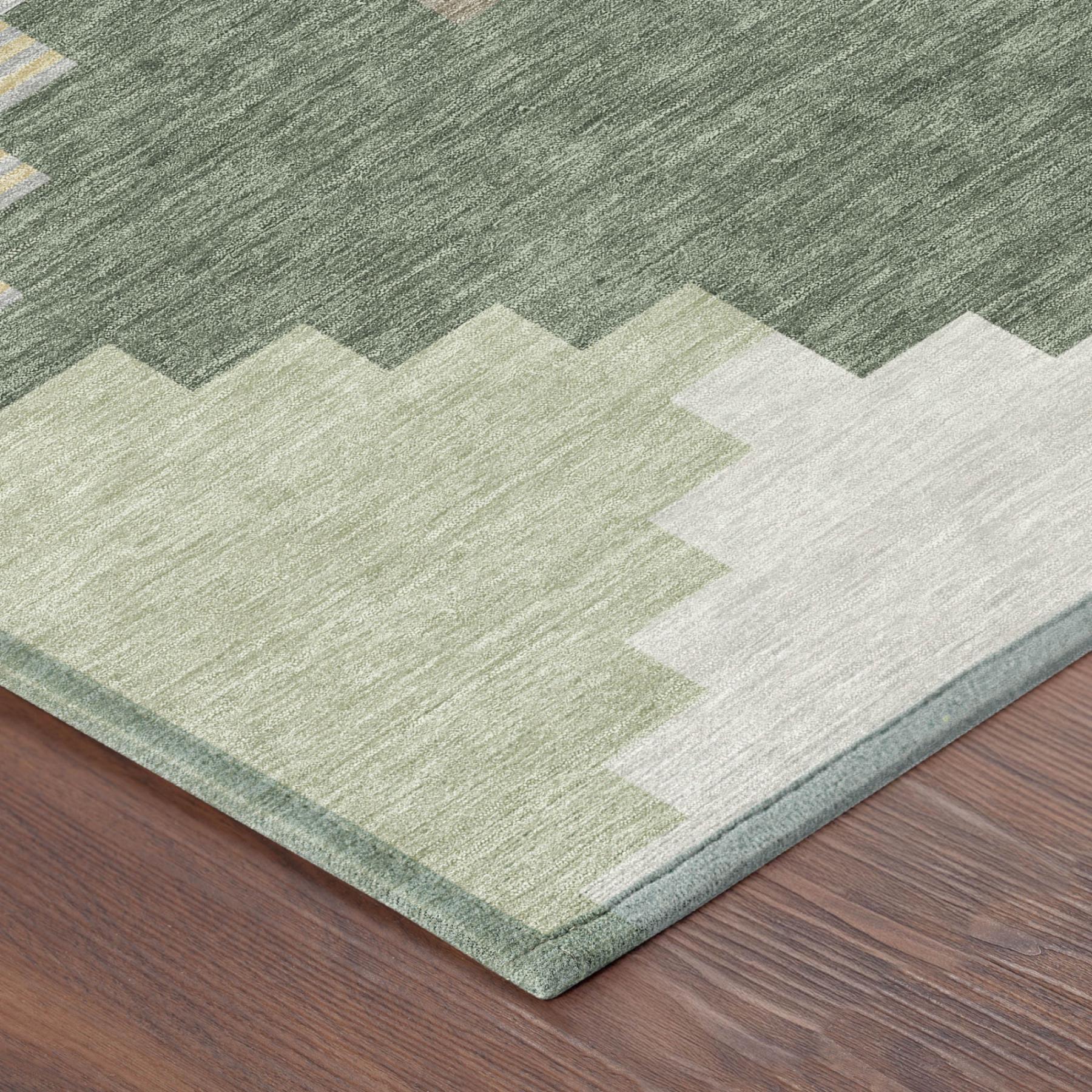 Geometric area rug corner with green, gray, and light beige blocks and border.