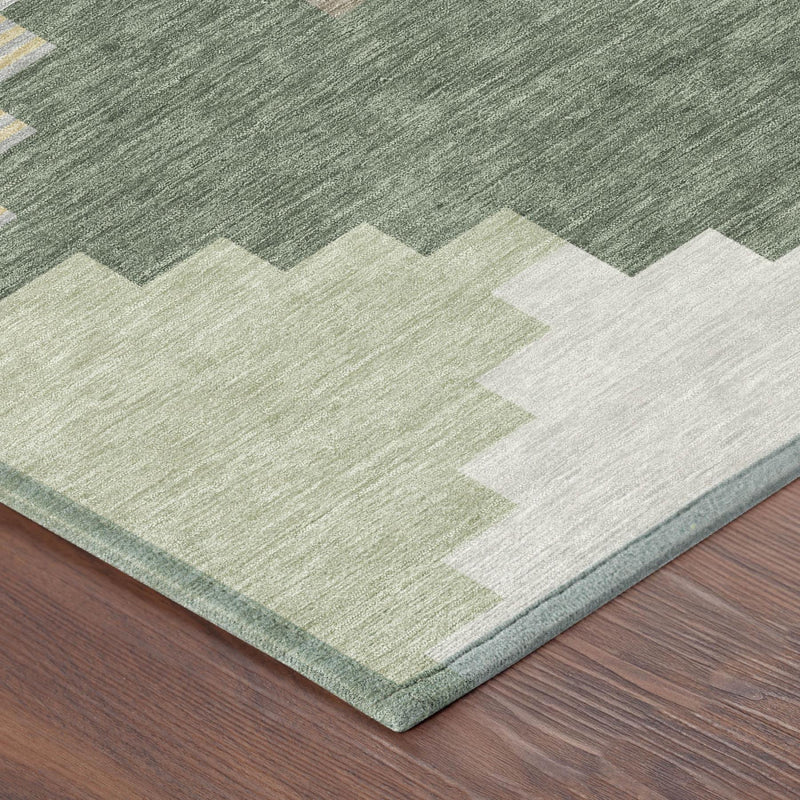 Geometric area rug corner with green, gray, and light beige blocks and border.