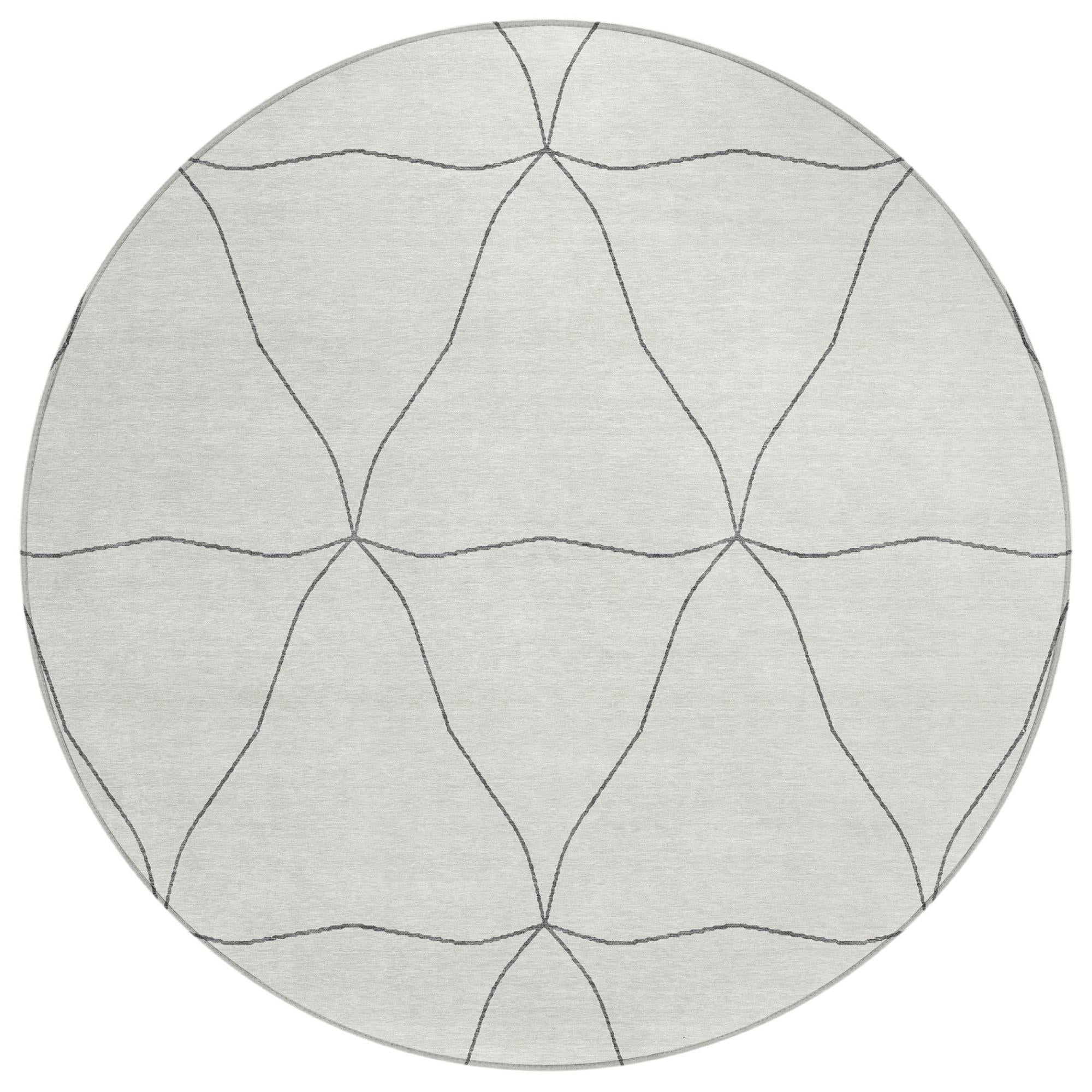 Round area rug with light gray base and repeating gray geometric line pattern