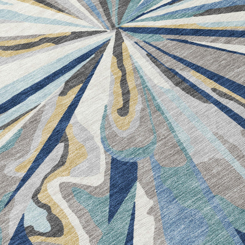 Close view of navy and light blue abstract sunburst area rug with beige streaks