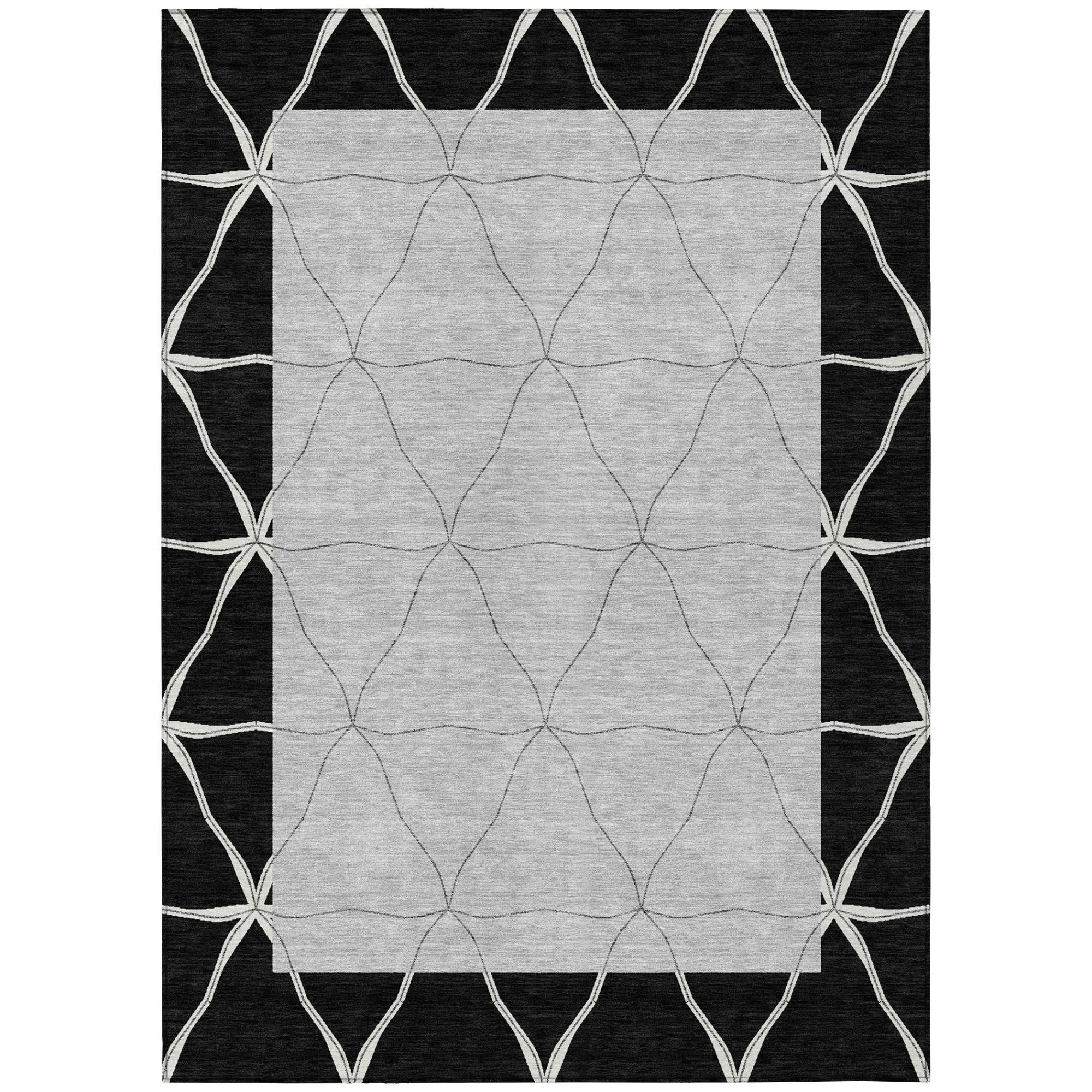 Black and silver geometric area rug with repeating diamond lattice center