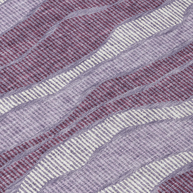 Close-up of round rug: wavy lilac, purple, and gray striped weave texture