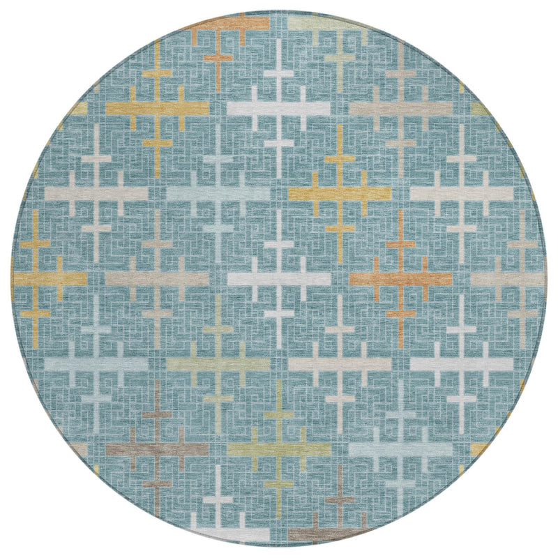 Round teal blue rug with repeating geometric cross pattern in silver and gold