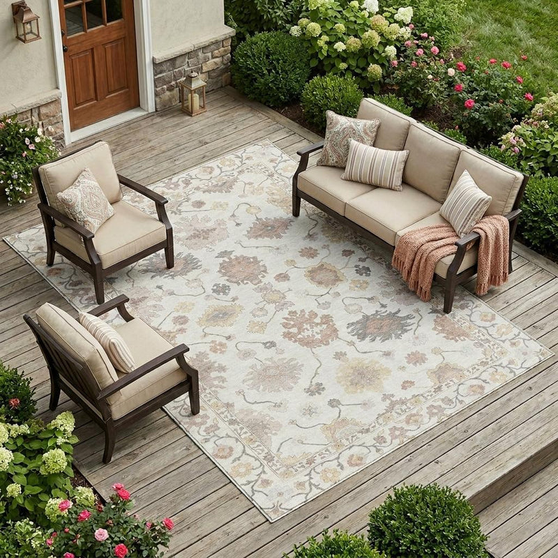 Ivory oriental area rug with pastel floral-and-medallion motif, muted tan, gray, and faded blue accents