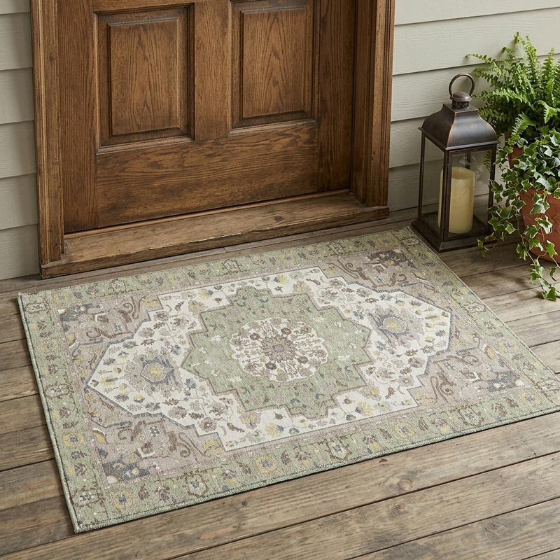 Rectangular oriental area rug with light green center medallion and cream patterned border.