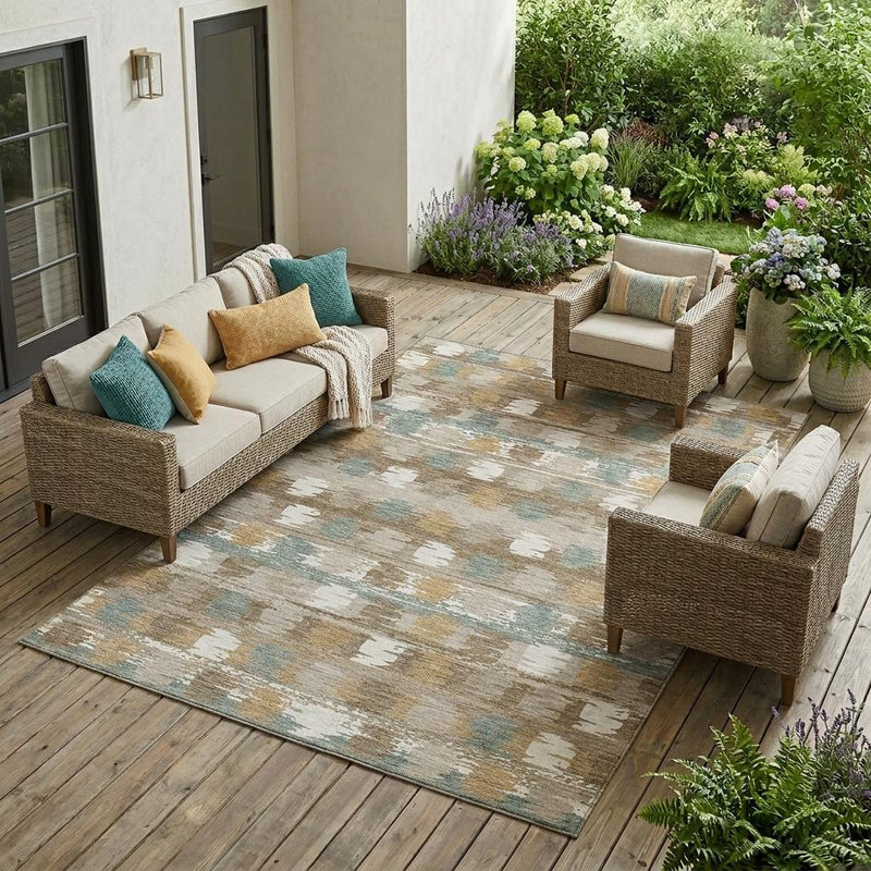 Abstract area rug with beige, brown, and aqua blocks and a distressed, textured look.