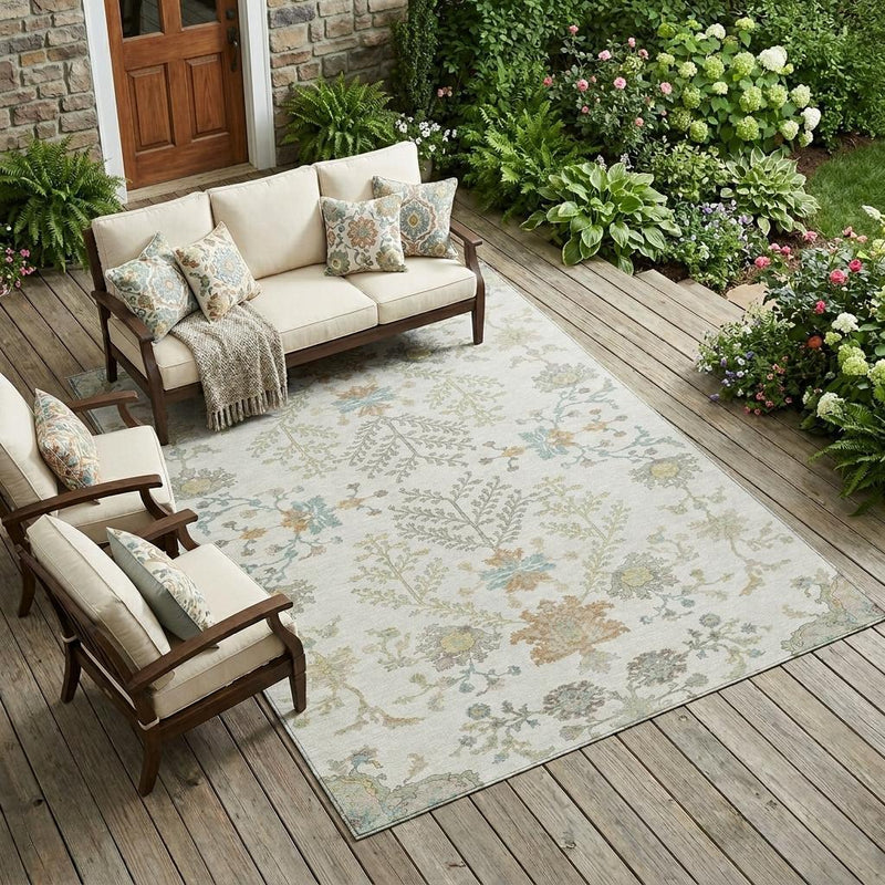 Ivory oriental area rug laid on outdoor deck, floral pattern in blue and sage tones