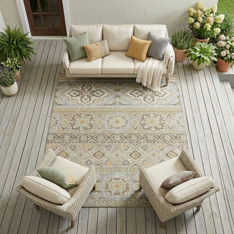 Beige and ivory tribal washable indoor outdoor area rug with distressed floral and geometric pattern.