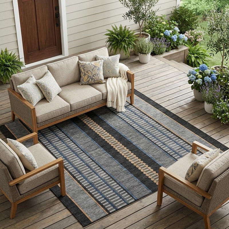 Striped indoor outdoor area rug laid on wooden patio with blue and copper accents