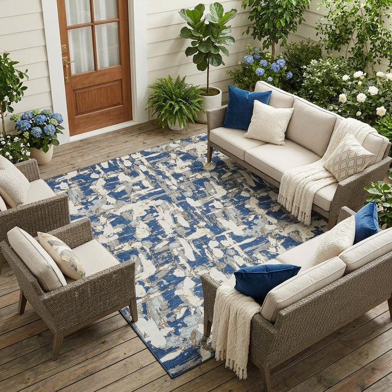 Navy and cream abstract area rug in a living room on wood flooring.