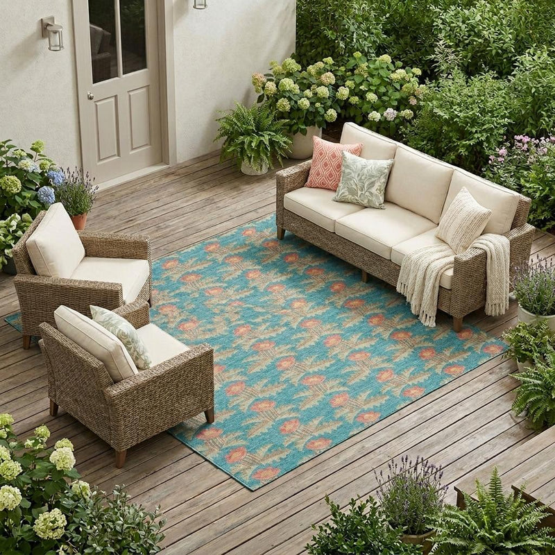 Turquoise floral area rug with coral blooms and geometric accents