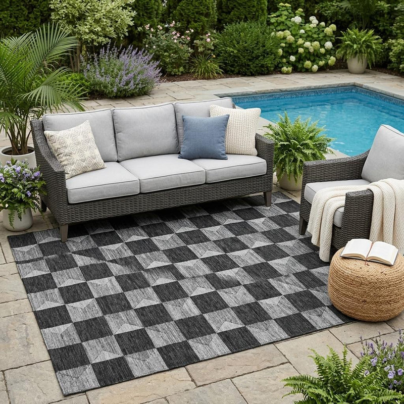 Geometric black and ivory area rug with checker-and-knot design