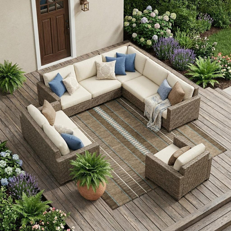 Outdoor sectional seating with striped area rug in tan, brown, and blue tones