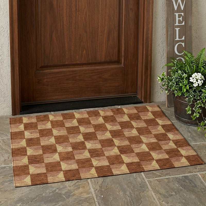Geometric outdoor area rug on a patio with brown and tan checker square pattern.