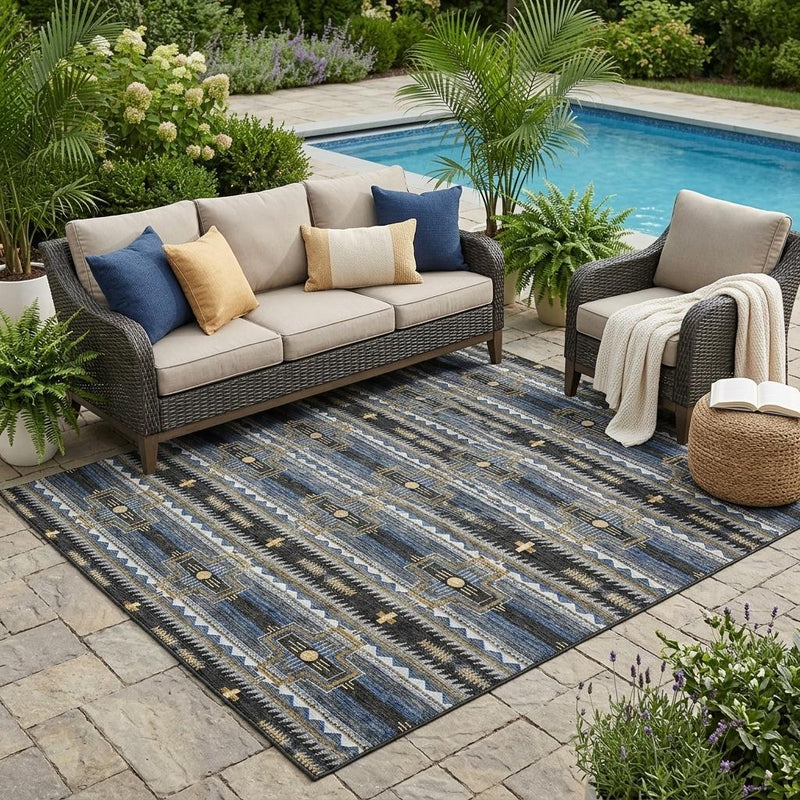 Outdoor area rug with tribal geometric pattern in dark and blue tones with gold accents